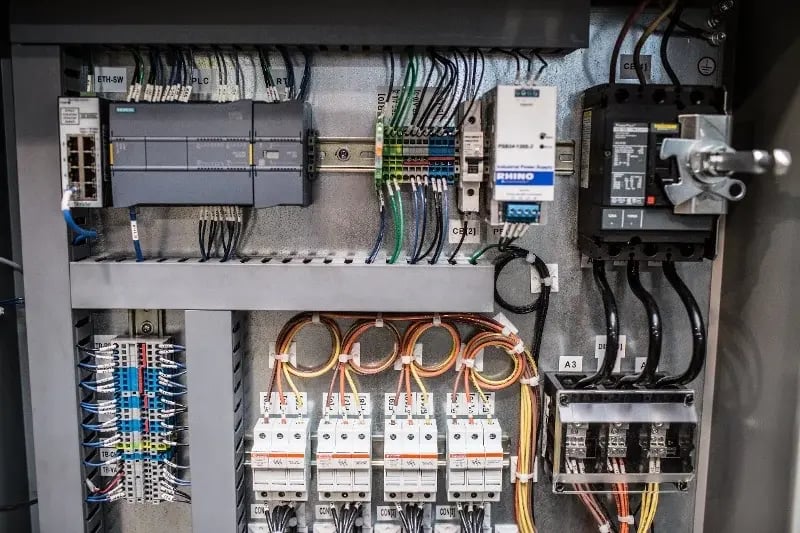 A custom process automation & batch control system featuring a control box with wires and programming technology