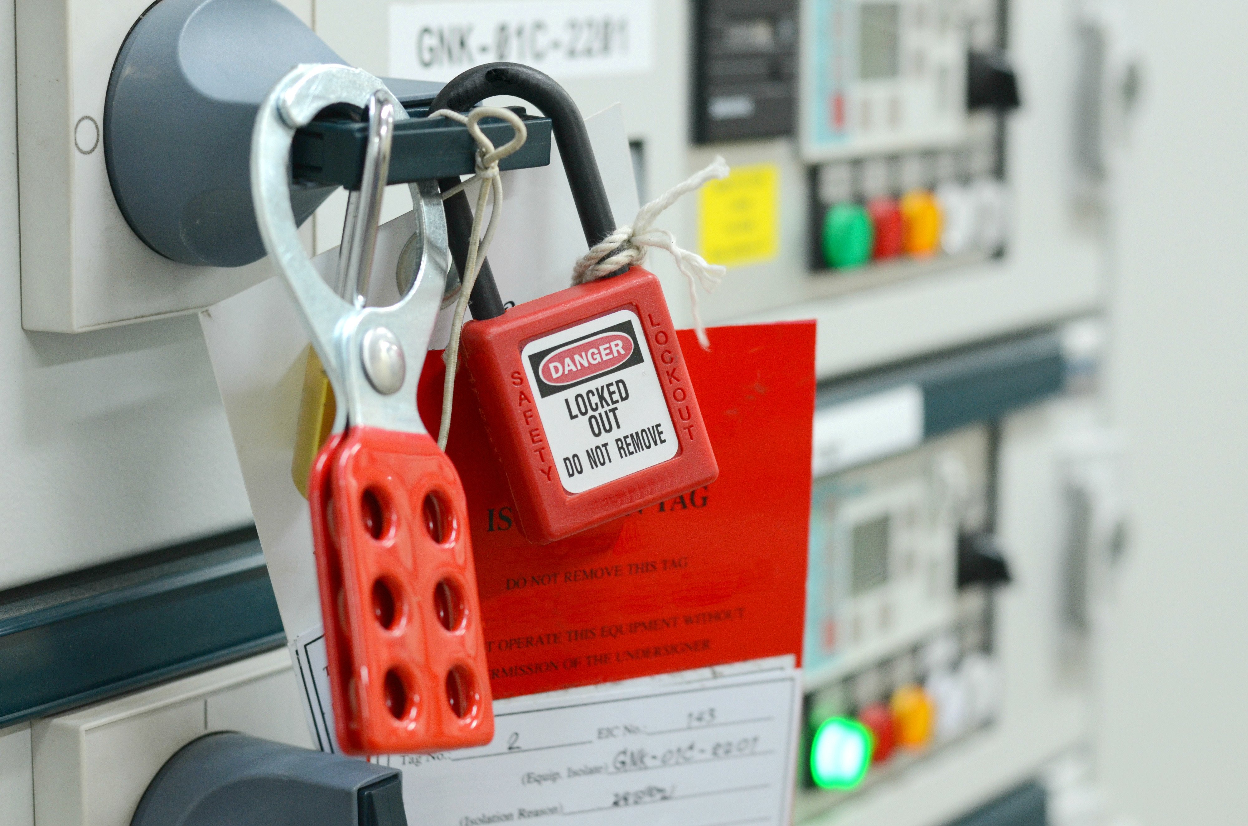 danger lock out signs and multiple locks on chemical machine door in lab