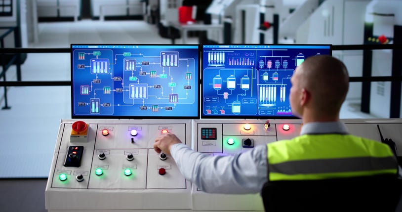 man in safety vest overseeing operations in lab