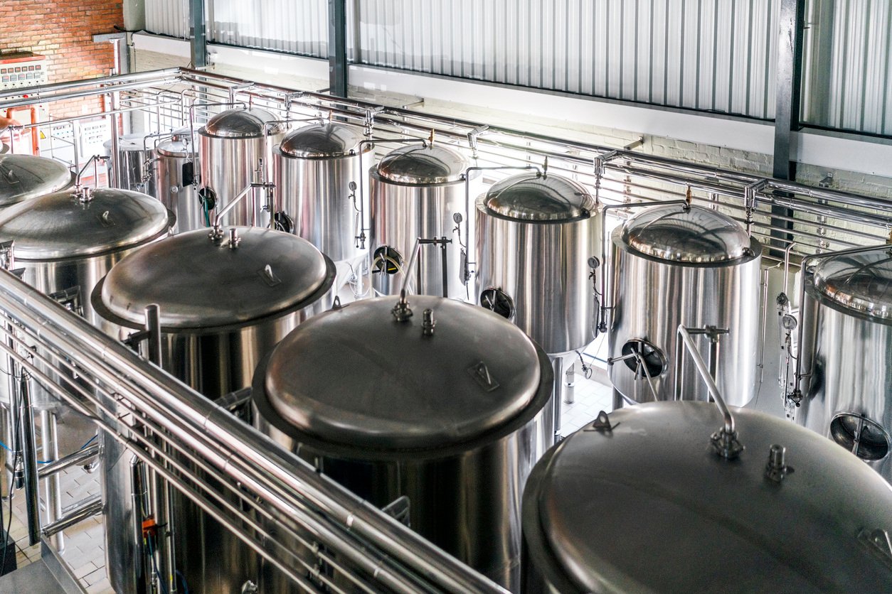 multiple stainless steel tanks in warehouse